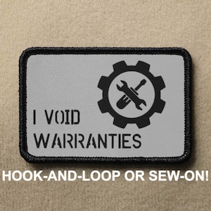 May include: A black and gray patch with a white background. The patch has a gear with a wrench and screwdriver crossed inside. The text "I VOID WARRANTIES" is below the gear.