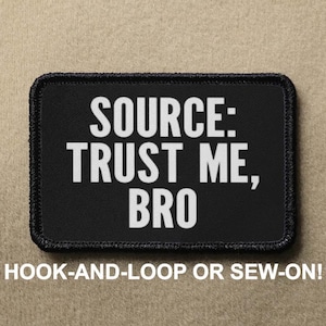May include: Black patch with white text that reads "SOURCE: TRUST ME, BRO". The patch has a black border and is designed to be attached with hook-and-loop or sewn on.