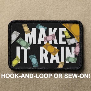 May include: Black patch with white text that reads "Make It Rain" surrounded by colorful cartoon money bills. The patch is for hook-and-loop or sew-on attachment.