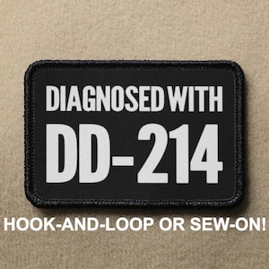 May include: Black patch with white text that reads "DIAGNOSED WITH DD-214" and "HOOK-AND-LOOP OR SEW-ON!"