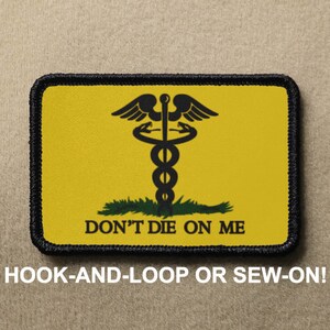 May include: Yellow patch with a black medical symbol and the text "DON'T DIE ON ME". The patch has a black border and is designed to be attached with hook-and-loop or sewn on.