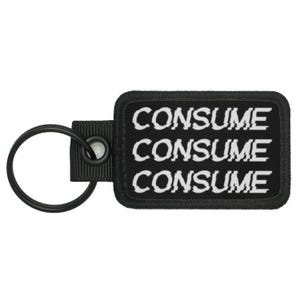 May include: Black key chain with a black rectangular tag that says "CONSUME" three times in white text.