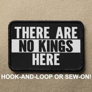 May include: Black and white patch with the text "THERE ARE NO KINGS HERE" in white letters. The patch is for hook-and-loop or sew-on attachment.
