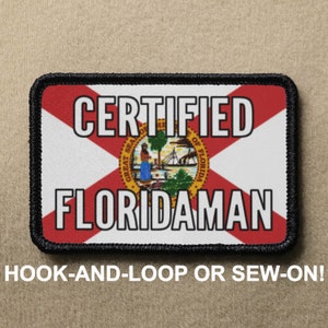 May include: A black and red patch with the text "CERTIFIED FLORIDAMAN" and the state seal of Florida. The patch is for hook-and-loop or sew-on attachment.