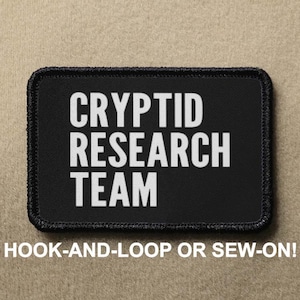 May include: A trio of cream-glazed ceramic mugs, each adorned with a hand-painted floral pattern in blue, green, and yellow. The mugs have a speckled finish and a classic, rounded design with a handle. Ideal for tea or coffee.