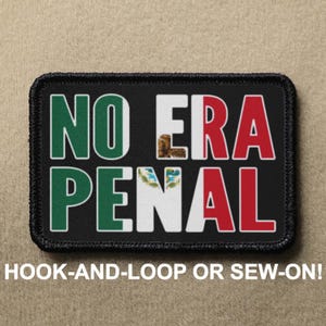 May include: A rectangular black patch with a stitched border featuring the text NO ERA PENAL in white letters. The letters are filled with the green, white, and red colors of the Mexican flag, including the central eagle emblem on the white section.
