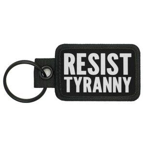 May include: Black key chain with a black and white patch that says "RESIST TYRANNY".