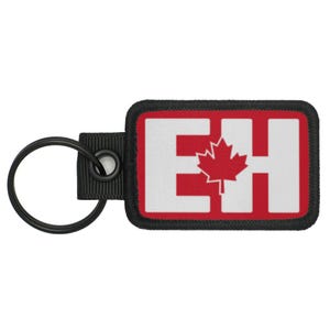 May include: A black key chain with a red and white patch that says "EH" with a red maple leaf in the middle.