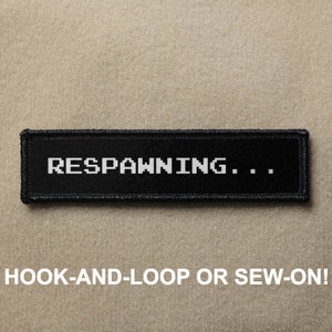 May include: Black patch with white text that reads "RESPAWNING..."  The patch has a hook-and-loop or sew-on backing.