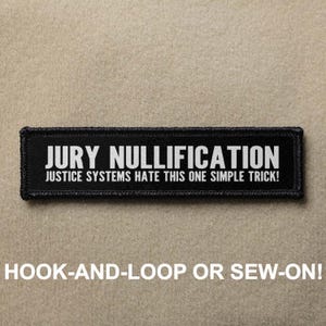 May include: Black and white patch with the text "JURY NULLIFICATION" and "JUSTICE SYSTEMS HATE THIS ONE SIMPLE TRICK!"  The patch is for hook-and-loop or sew-on attachment.