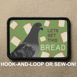 May include: A green and white patch featuring a cartoon pigeon and the text "Lets Get This Bread". The patch is bordered in black and can be attached with hook-and-loop or sewn on.