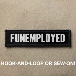 May include: Black patch with white text that reads "FUNEMPLOYED". The patch is designed to be sewn or attached with hook and loop.