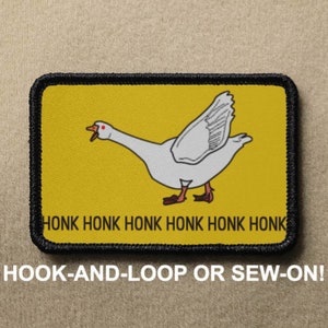 May include: A yellow patch with a white goose illustration and the text "HONK HONK HONK HONK HONK HONK". The patch has a black border and is labeled "HOOK-AND-LOOP OR SEW-ON!"
