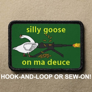 May include: A green patch with a black border. It depicts a white goose operating a machine gun, with yellow text reading "silly goose on ma deuce". The bottom text says "HOOK-AND-LOOP OR SEW-ON!"