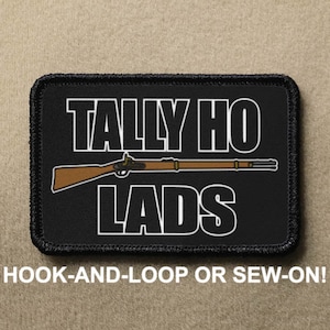 May include: Black patch with white text that reads "Tally Ho Lads" and a brown and black rifle illustration. The patch has a black border and is labeled "Hook-and-Loop or Sew-On!"