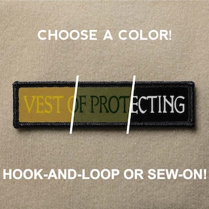 Op de afbeelding: Een zwarte, groene en gele patch met de tekst "VEST OF PROTECTING". De patch is verkrijgbaar in klittenband of naai-optie.