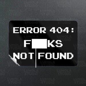 May include: A black and white sticker with the text "ERROR 404: FKS NOT FOUND" in a pixelated font. The sticker is designed to look like a computer error message.