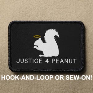 May include: Black and white patch with a white squirrel wearing a halo. The text "JUSTICE 4 PEANUT" is printed below the squirrel. The patch is for hook-and-loop or sew-on.
