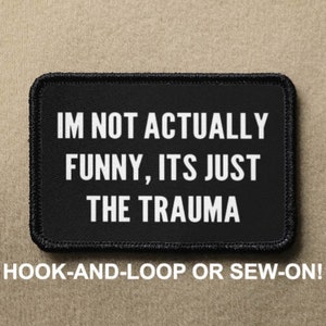 May include: Black and white patch with the text "IM NOT ACTUALLY FUNNY, ITS JUST THE TRAUMA" on a black background. The patch is for hook-and-loop or sew-on attachment.