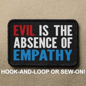 May include: Black patch with white stitching around the edges. The patch has the text "EVIL IS THE ABSENCE OF EMPATHY" in red, white, and blue lettering. The text "HOOK-AND-LOOP OR SEW-ON!" is printed below the patch.