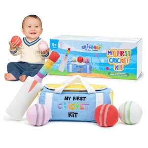 May include: A soft cricket toy set including a white and rainbow-striped bat, a light blue and yellow carry bag with the text My First Cricket Kit, and three plush balls in pink, red, and white with stitched details, plus a matching box.