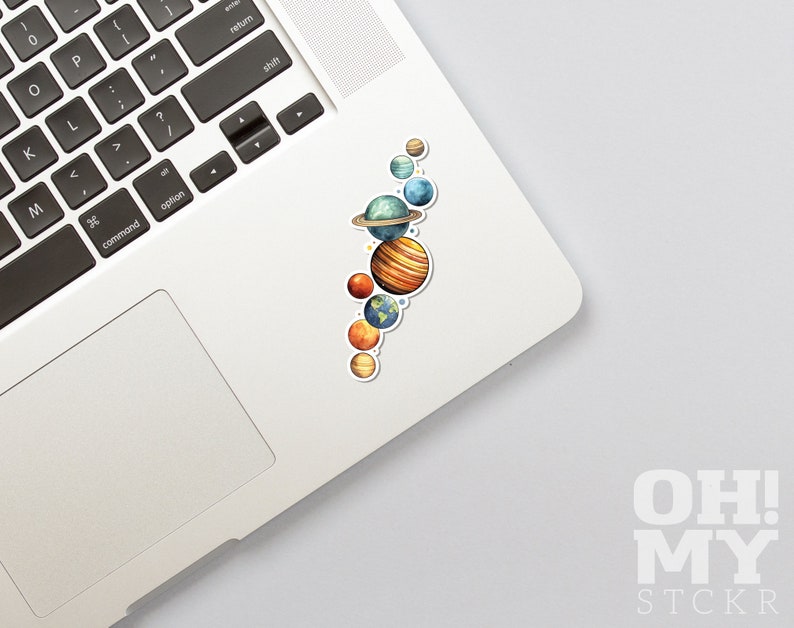 May include: A sticker featuring a watercolor illustration of the planets in our solar system. The planets are arranged vertically, with the sun at the top and the other planets below. The planets are painted in realistic colors, with details like rings and clouds.