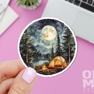Puede incluir: Una ilustraci&oacute;n de acuarela de un campamento bajo la luna llena. La escena presenta una tienda de campa&ntilde;a, una fogata y &aacute;rboles silueteados contra el cielo nocturno. La luna es de un blanco brillante con un suave resplandor.