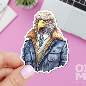 May include: A sticker featuring an eagle with a human-like appearance, wearing a blue jacket, tie, and a serious expression. The sticker has a watercolor effect and the text "OH MY STCKR" is visible in the bottom right corner.