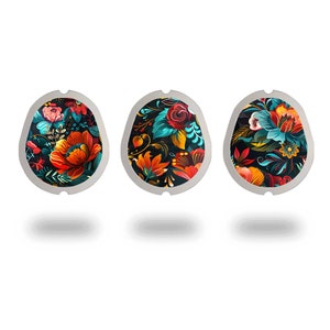 May include: Three round, silver-colored, decorative stickers with a floral pattern. The pattern features red, orange, yellow, blue, and green flowers on a black background.