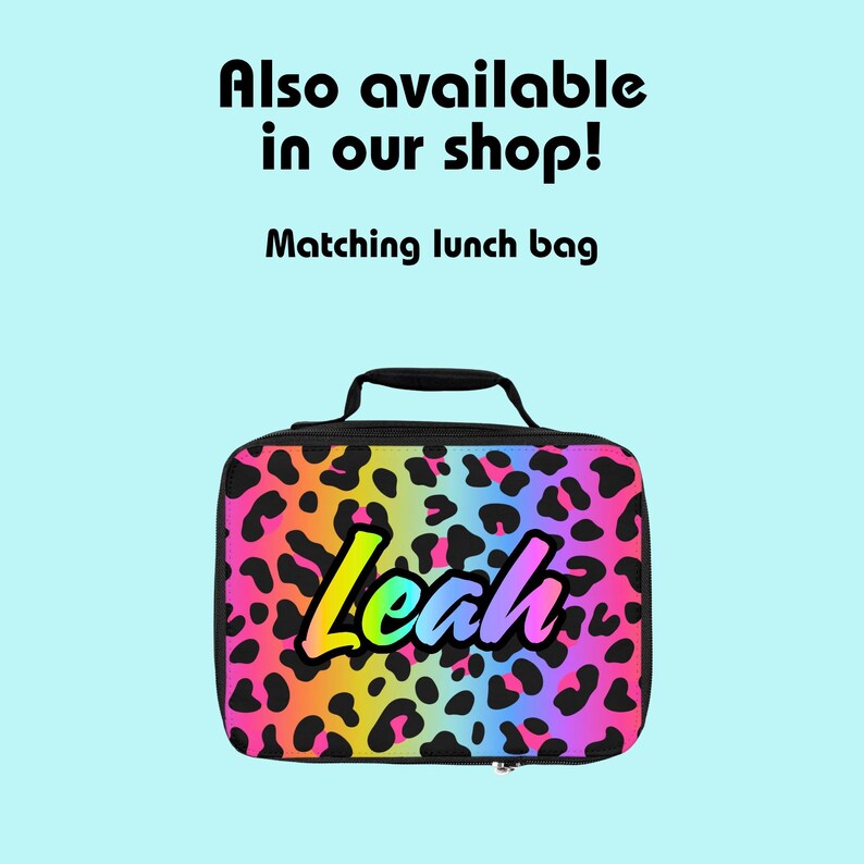 May include: A black lunch bag with a rainbow leopard print design. The name "Leah" is written in rainbow letters on the front of the bag.