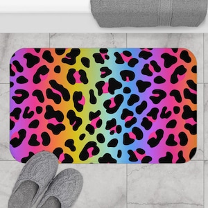 May include: A rainbow-colored bath mat with a leopard print pattern. The mat is made of a soft, absorbent material and is perfect for adding a touch of fun to your bathroom.