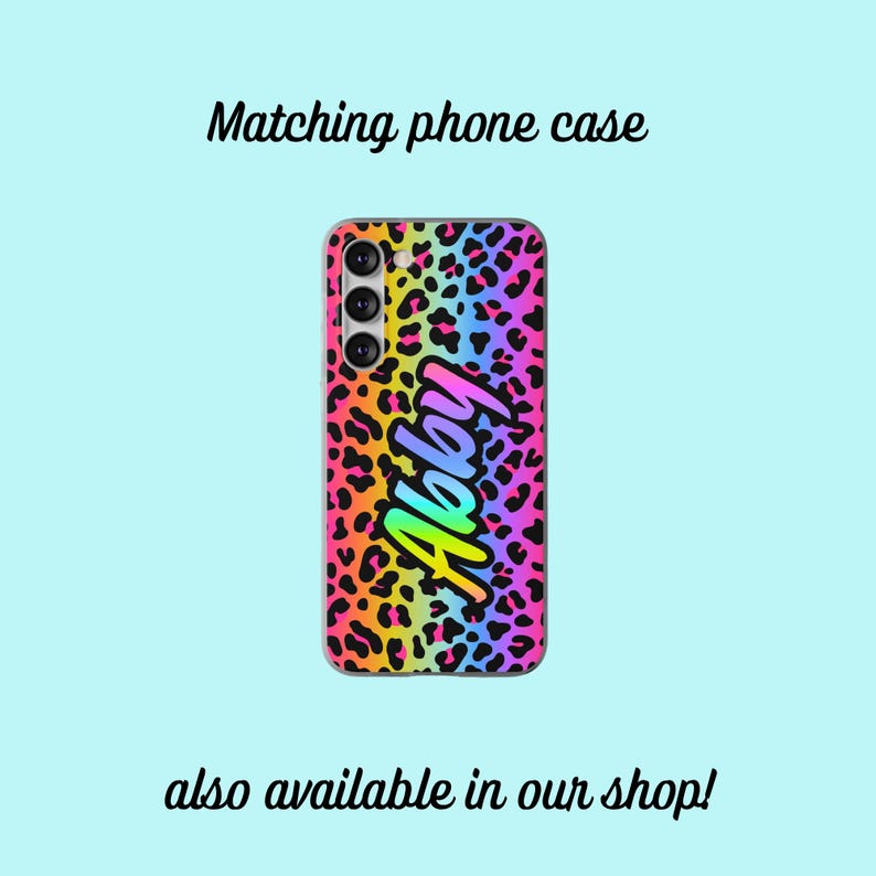 May include: A phone case with a leopard print background and a rainbow gradient design. The name "Abby" is written in a rainbow gradient font on the case.