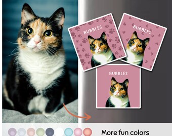 以下が含まれることがあります： 猫の顔と「Bubbles」という文字が書かれたピンク色の正方形のステッカーが3枚。猫は三毛猫で緑色の目。ステッカーには肉球とハートが描かれている。