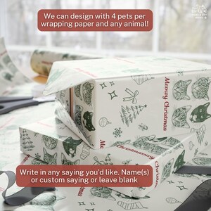 May include: White wrapping paper featuring a repeating pattern of dark green line-art cat faces, Christmas trees, snowflakes, and ornaments. The text Meowy Christmas is printed in red. The paper is wrapped around rectangular boxes.