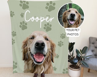 May include: A green fleece blanket with a paw print pattern. The blanket features a personalised illustration of a golden retriever dog with the name "Cooper" printed on the blanket. The blanket also includes a smaller image of a golden retriever dog in a circle with the text "YOUR PET PHOTOS".