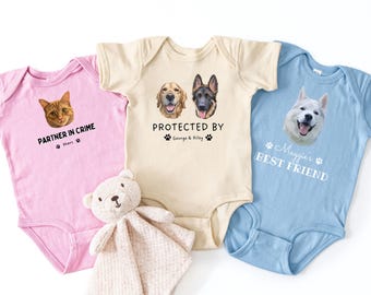 May include: Three baby onesies in pink, cream, and light blue. The pink one has a cat graphic and the text "PARTNER IN CRIME". The cream one says "PROTECTED BY" with dog faces. The blue one says "Maggie's BEST FRIEND".