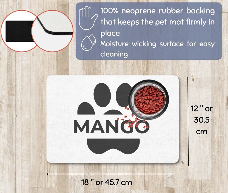 May include: A white pet mat with a black paw print design and the name "MANGO" in bold letters. A stainless steel bowl filled with pet food sits on the mat. The mat is 18 inches long and 12 inches wide.