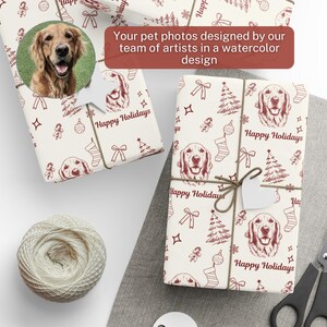 May include: Wrapping paper featuring a repeating pattern of dark red line art illustrations of a golden retriever dog, Christmas trees, stockings, bows, and ornaments on a white background with the text Happy Holidays printed throughout.