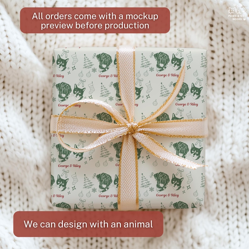 May include: A square gift box wrapped in light-colored paper featuring a repeating dark green pattern of dog and cat faces, Christmas trees, stockings, and ornaments, with the text George & Riley, tied with a shimmering gold ribbon.
