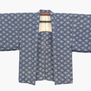 May include: A blue kimono with a geometric diamond pattern. The kimono is displayed open, revealing a striped lining. The sleeves are wide and rectangular. The garment is hanging on a wooden hanger.