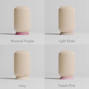 May include: Four ceramic candle holders with different colored bases. The bases are Morandi Purple, Light Khaki, Ivory, and Peach Pink.