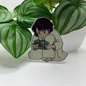 May include: A sticker of a cartoon girl with brown hair, wearing a beige robe, sitting on the floor and holding a stack of money.