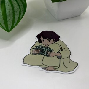 May include: A sticker of a cartoon person sitting with a large stack of money in their lap.