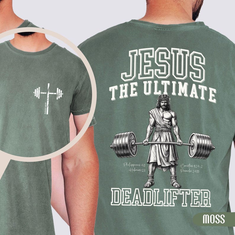 May include: Moss green t-shirt with a white graphic of a barbell cross on the front. The back features the text "JESUS THE ULTIMATE DEADLIFTER" with an illustration of Jesus lifting a barbell. Includes Bible verses.
