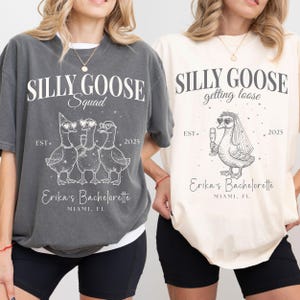 May include: Two t-shirts, one dark gray and one cream, with the text "SILLY GOOSE" and goose illustrations. The dark gray shirt says "Squad" and the cream shirt says "getting loose". Both shirts have "Erika's Bachelorette" and "Miami, FL".