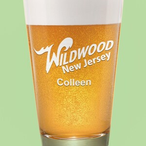 May include: A glass of beer with a white head and a label that says "Wildwood New Jersey" and "Colleen".