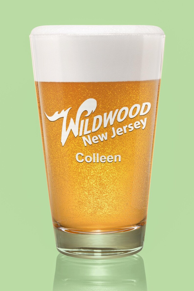 May include: A glass of beer with a white head and a label that says "Wildwood New Jersey" and "Colleen".