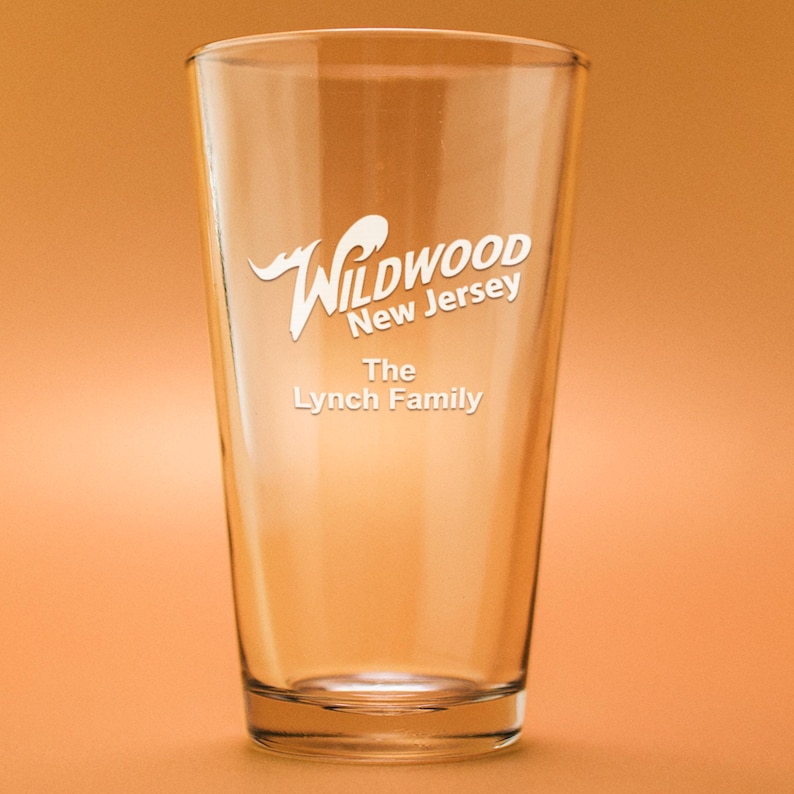 May include: A clear glass pint glass with a white design that says "Wildwood New Jersey" and "The Lynch Family".