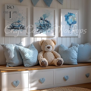 May include: A white bench with three drawers and blue heart-shaped pulls. The bench is decorated with blue and white pillows and a teddy bear. Three framed watercolor prints hang on the wall above the bench. The prints feature a car, a train, and a hot air balloon.