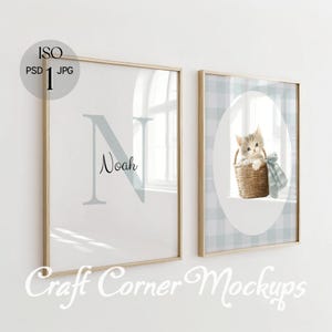 May include: Two framed prints. One features a large, light blue letter "N" with the name "Noah" in script. The other print shows a kitten in a wicker basket with a blue bow, set against a blue and white plaid background. The frames are light wood.